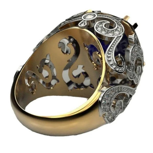 Gold and silver ring with intricate design on a white background