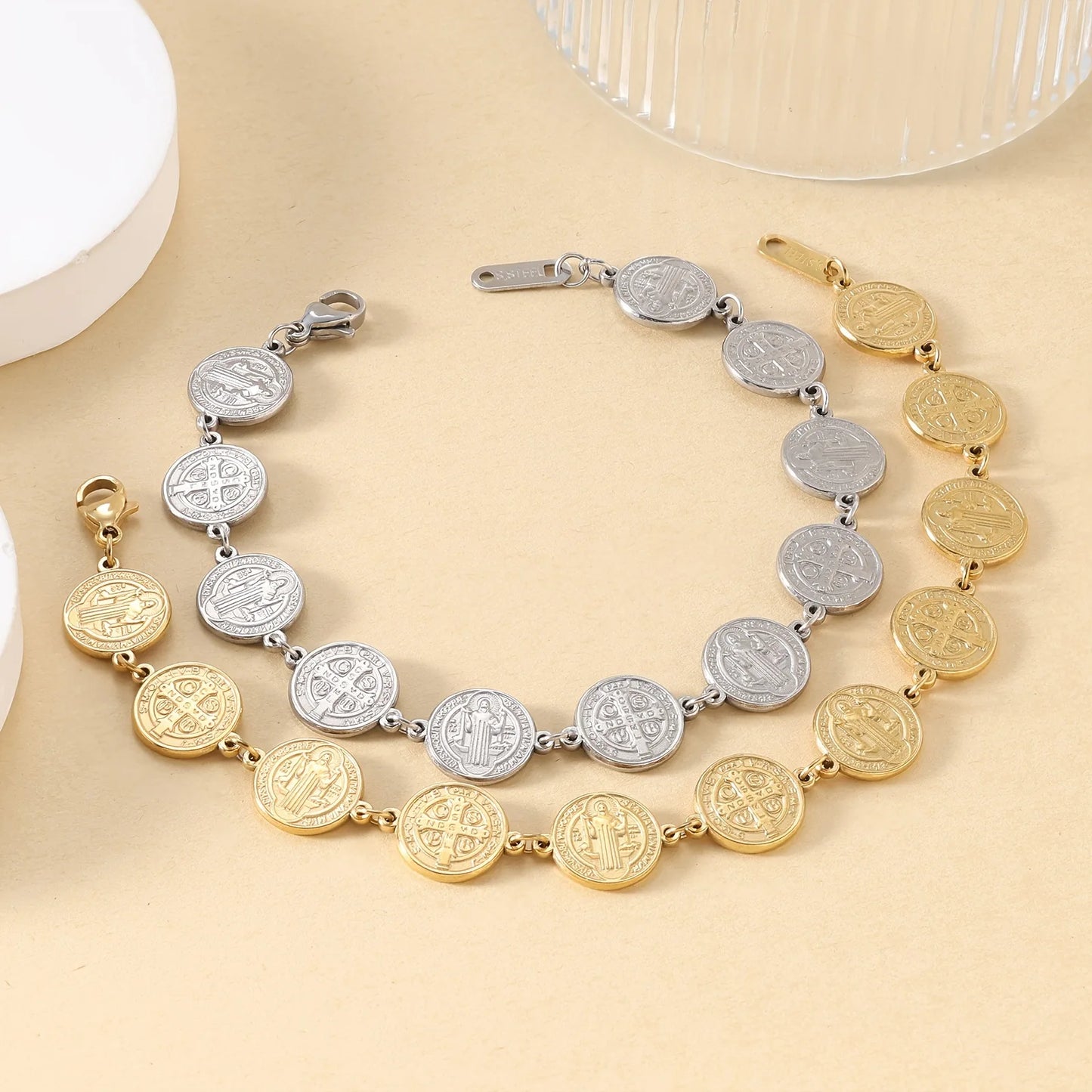 Two necklaces with coin-style beads on a beige surface