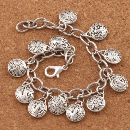 Silver bracelet with circular charms on a brown surface