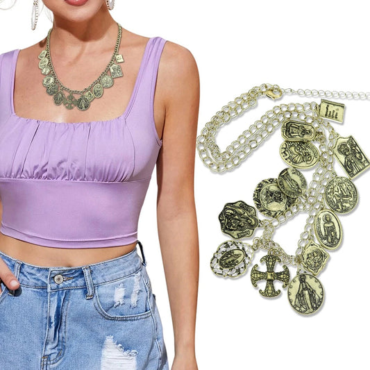 Purple top, denim shorts, and a necklace with religious charms on a white background