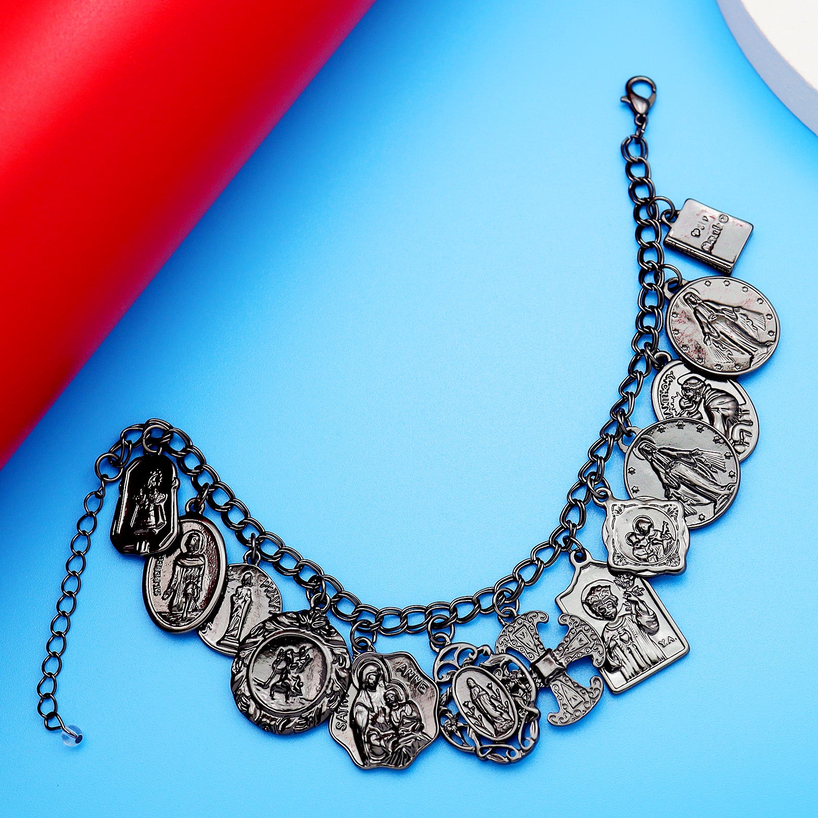 Silver charm bracelet on a blue background