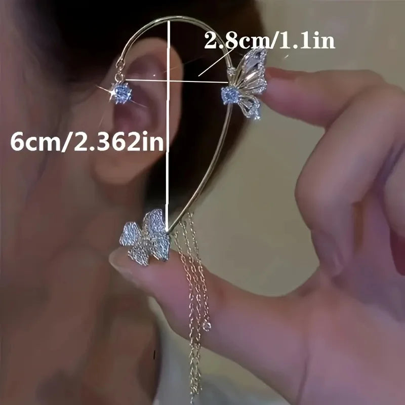 Butterfly-shaped earrings being held with measurements displayed