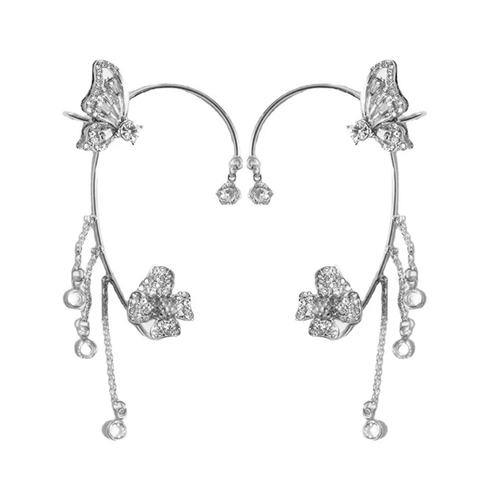Silver butterfly and floral earrings on a white background