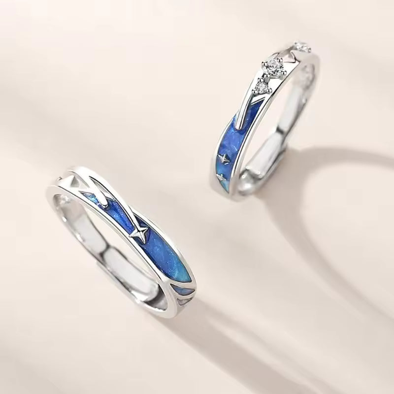 Two silver rings with blue inlay on a light beige background