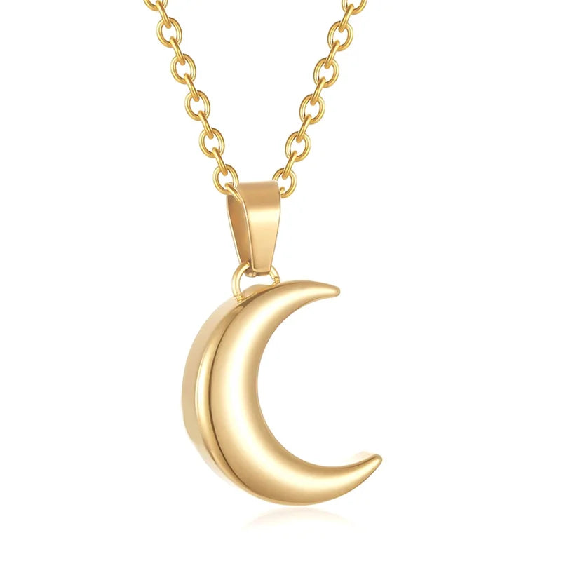 Gold crescent moon necklace on a white background