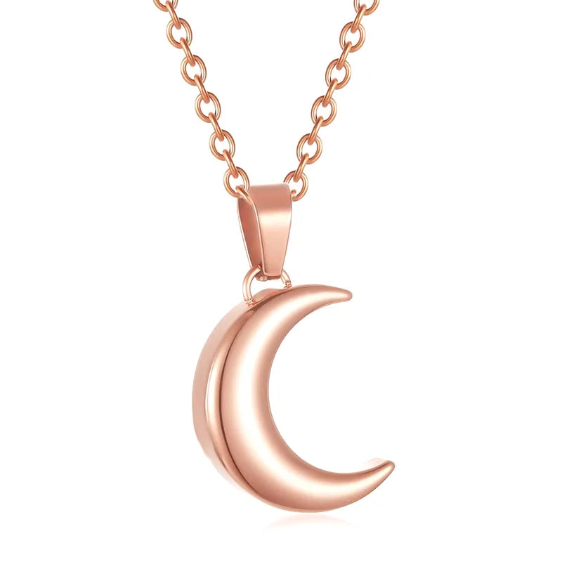 Rose gold crescent moon necklace on a white background