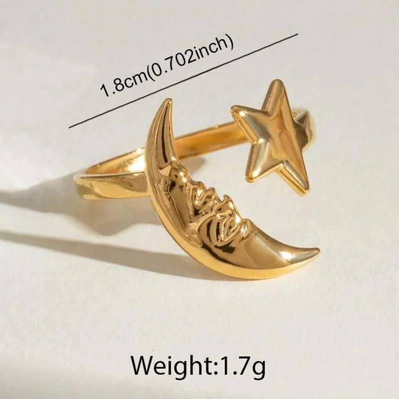 Gold crescent moon and star earring with measurements and weight on a white background