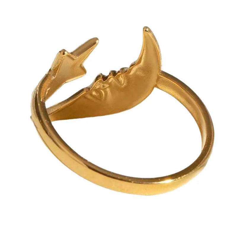 Gold ring with shark design on a white background