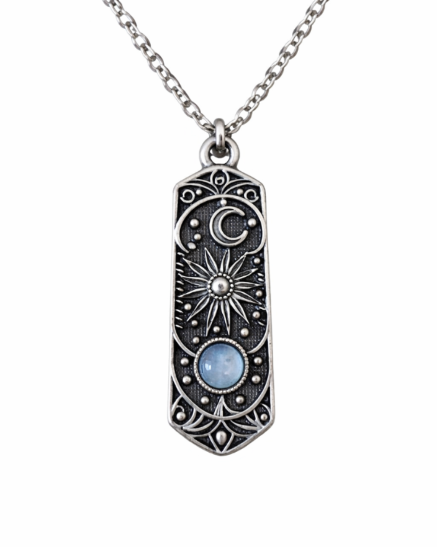 Silver pendant necklace with star and moon design on a white background