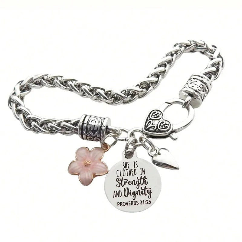 Silver bracelet with floral charm and bible verse tag on a white background