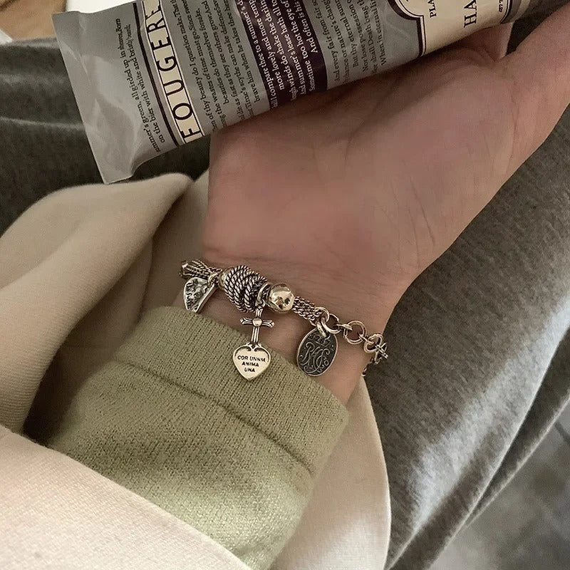 Hand wearing a bracelet with charms