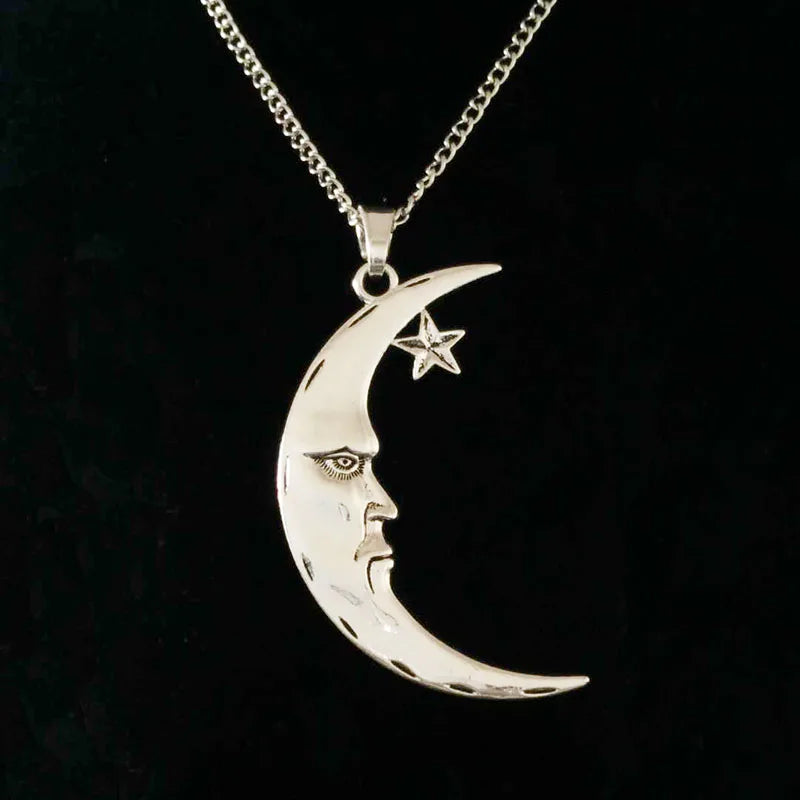 Silver crescent moon and star pendant on a black background