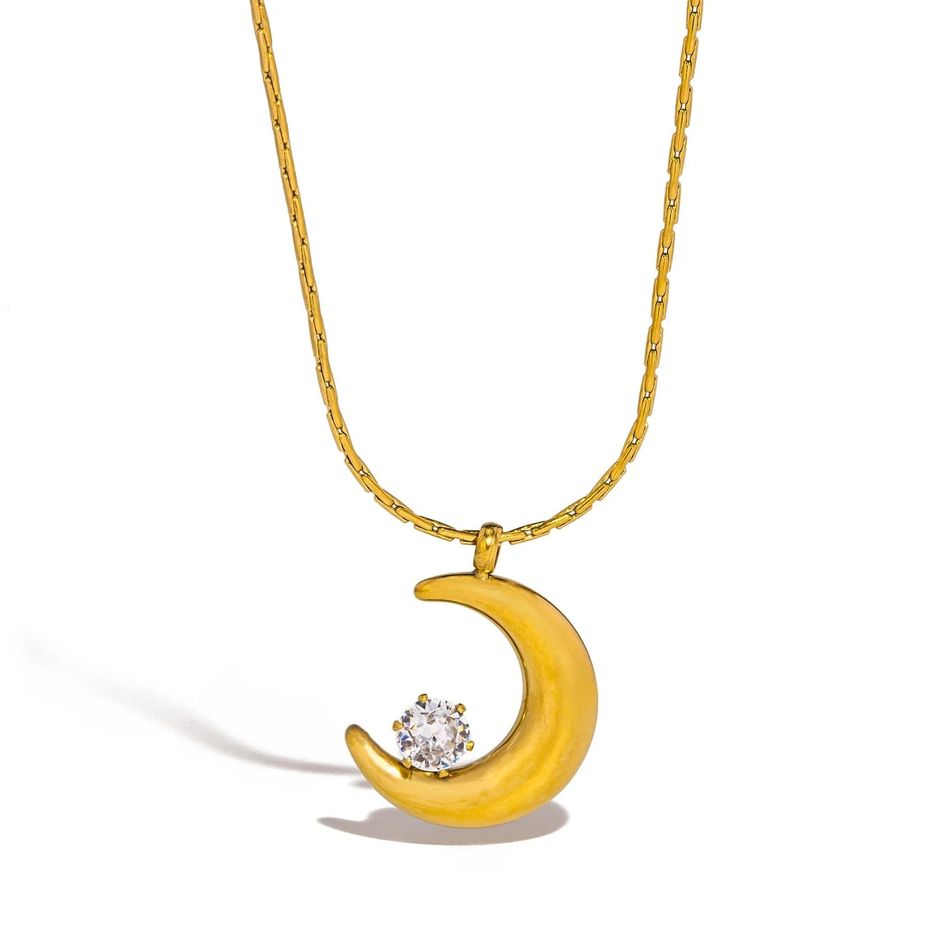 Gold crescent moon necklace with a diamond on a white background.