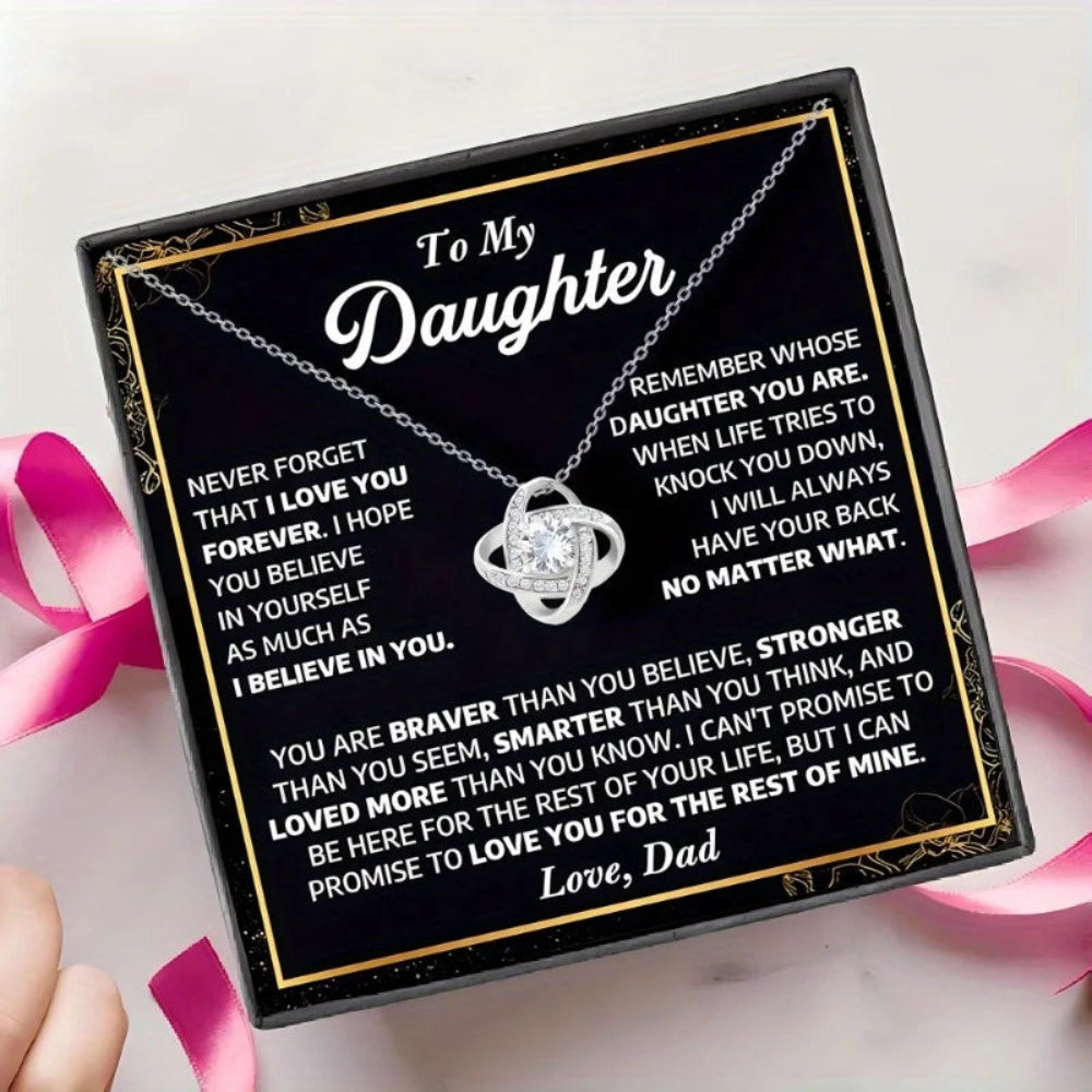 Necklace in a black box with a message to a daughter from a dad, surrounded by pink ribbons.