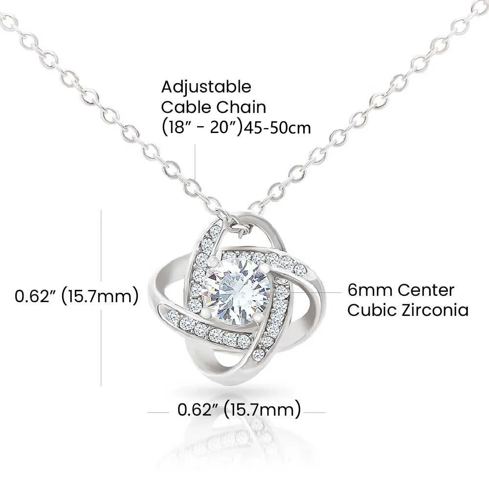 Silver necklace with adjustable cable chain and cubic zirconia pendant on a white background