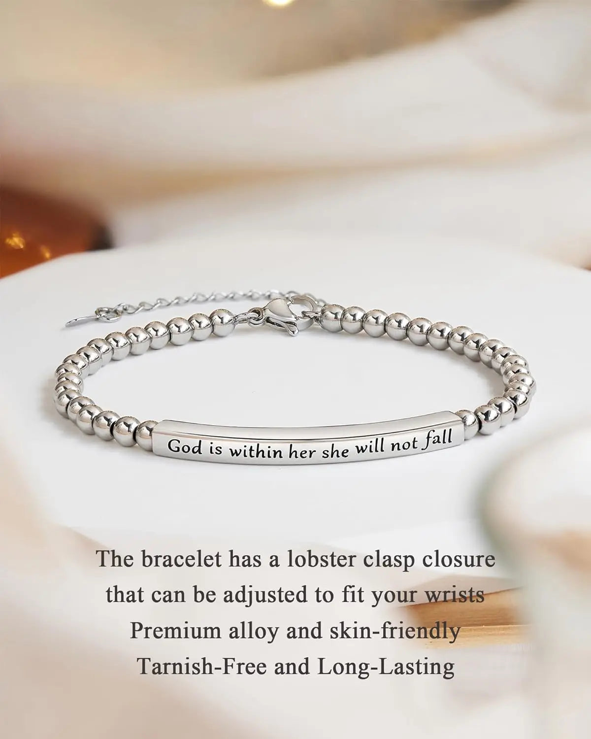 Silver bracelet with engraved message on a white surface