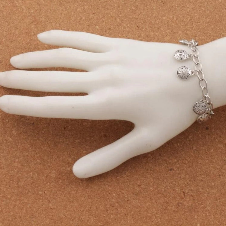 Silver bracelet on a mannequin hand.