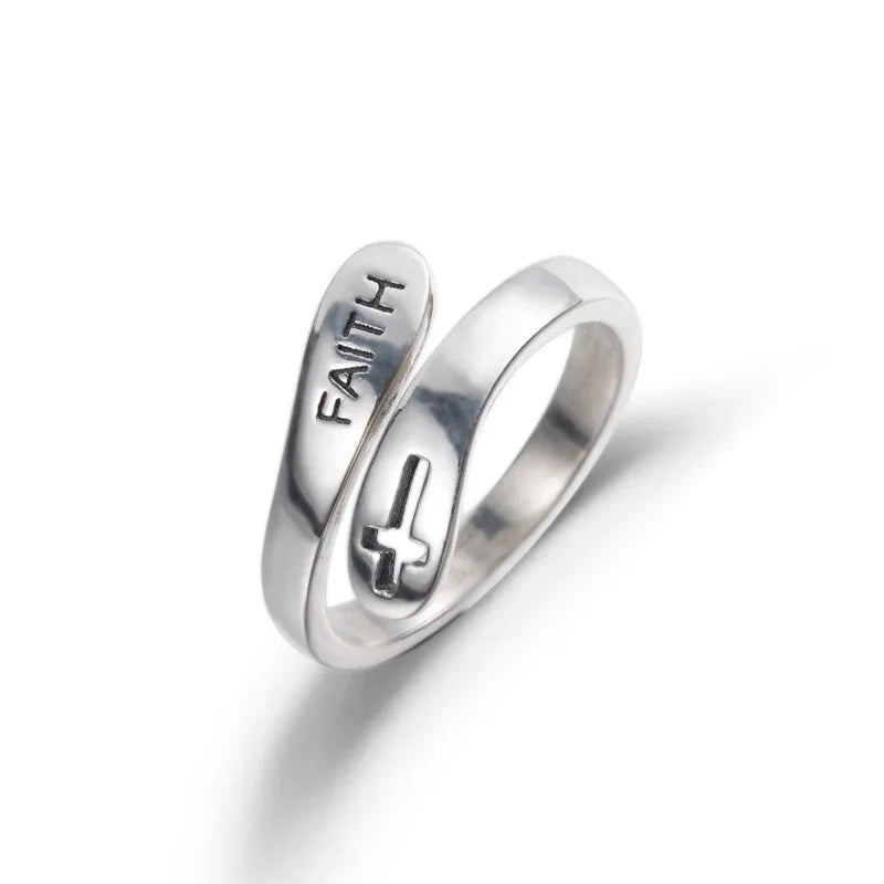 Silver ring with 'FAITH' engraving on a white background