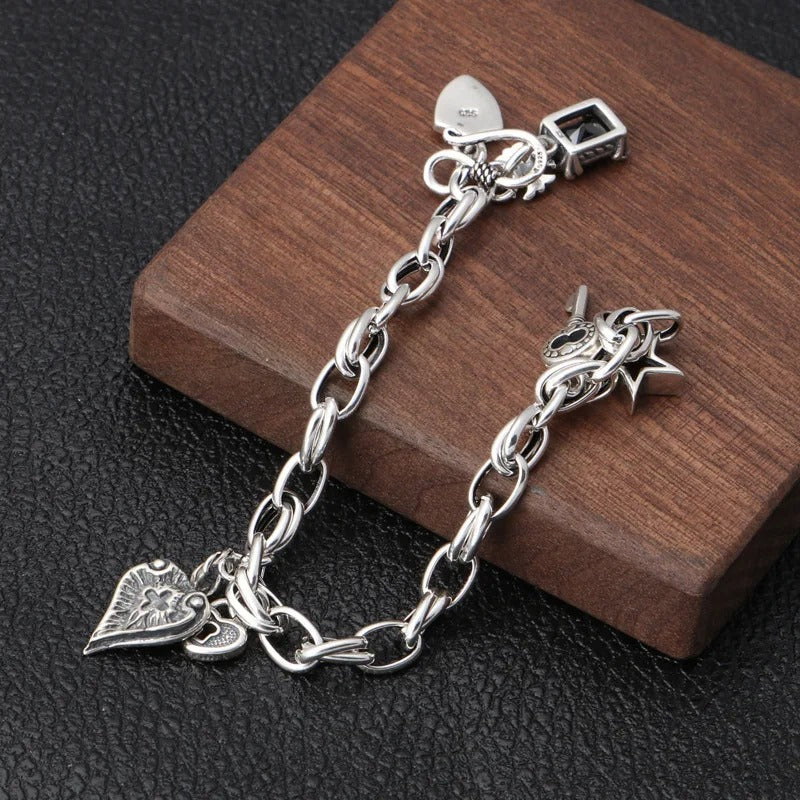 Silver bracelet with charms on a wooden block