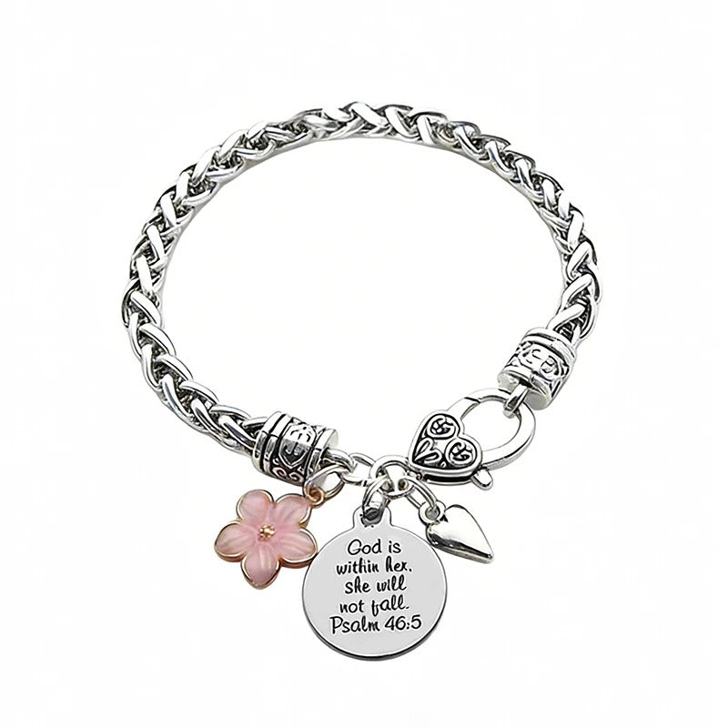 Silver bracelet with floral charm and engraved tag on a white background