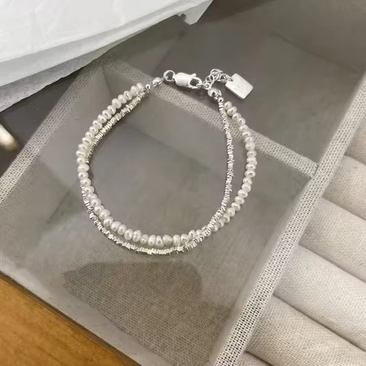 Pearl bracelet on a textured surface