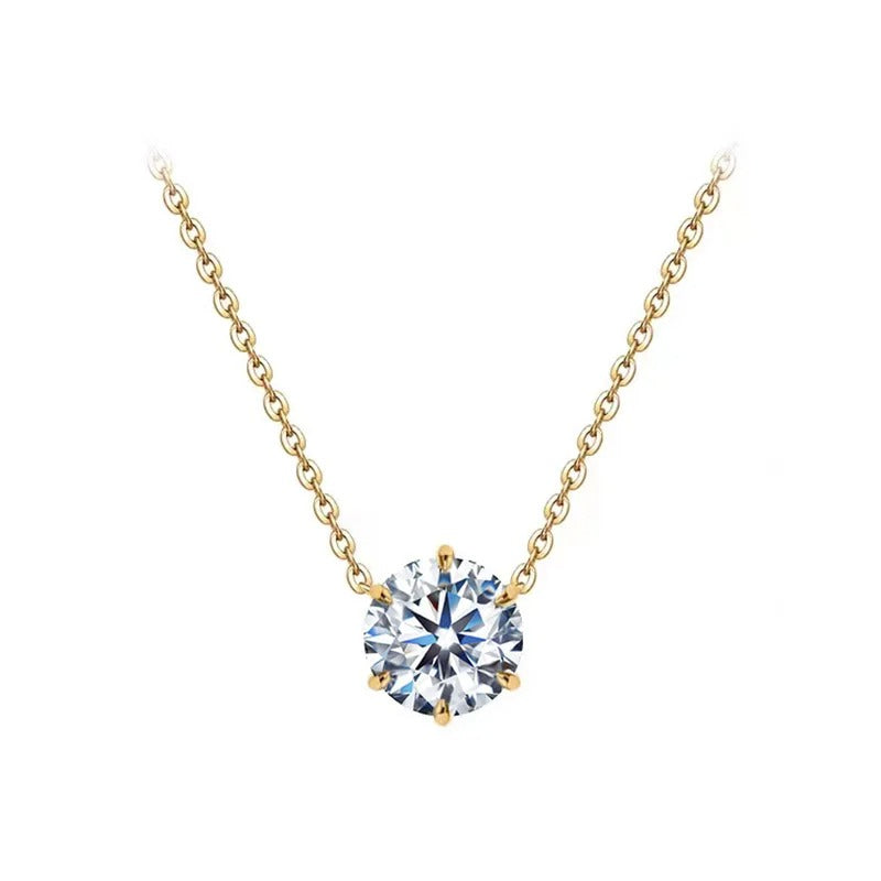 Gold necklace with a round diamond pendant on a white background