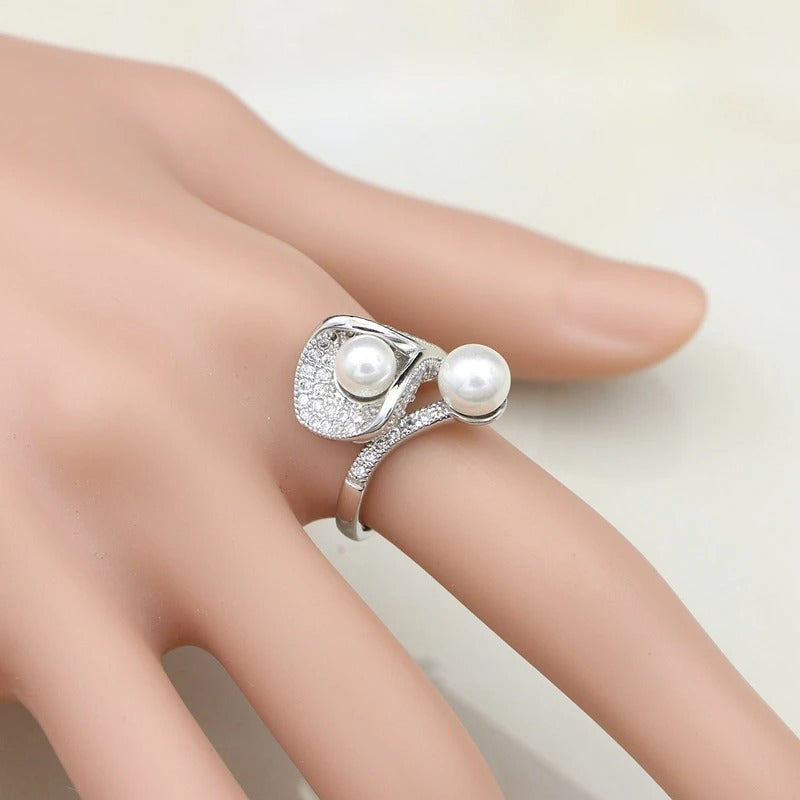 adjustable sterling silver ring on finger with freshwater pearl and zircon accents