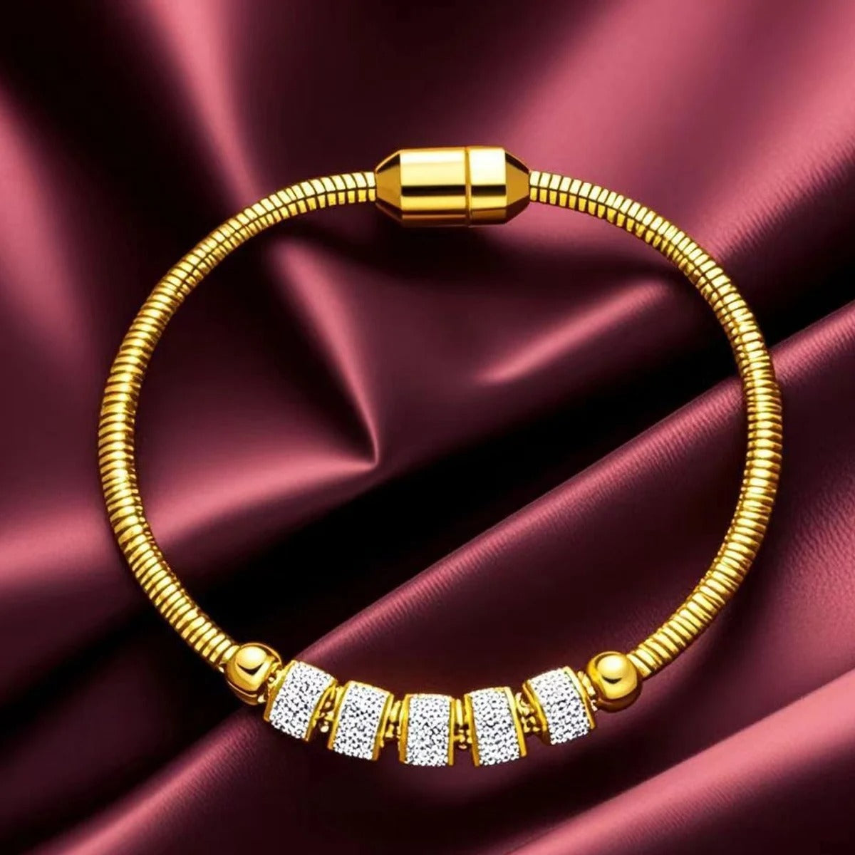 Gold bracelet with diamond accents on a maroon satin background