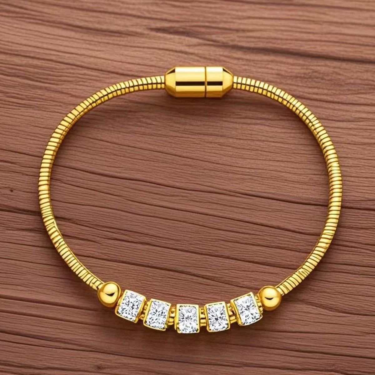 Gold bracelet with diamond accents on a wooden surface