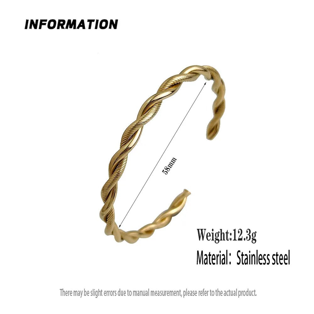 Gold twisted ring with measurement details on a white background