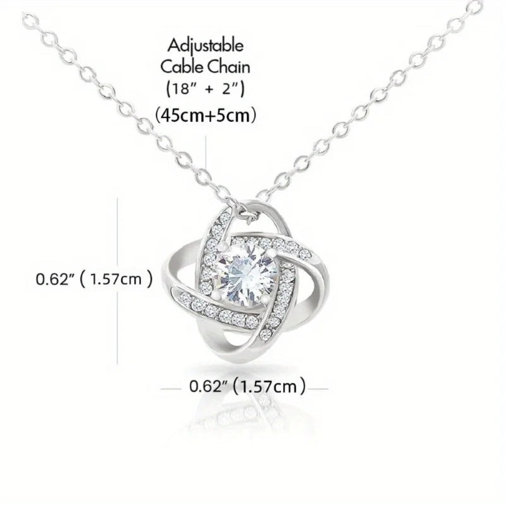 Silver necklace with heart-shaped pendant and adjustable cable chain on a white background