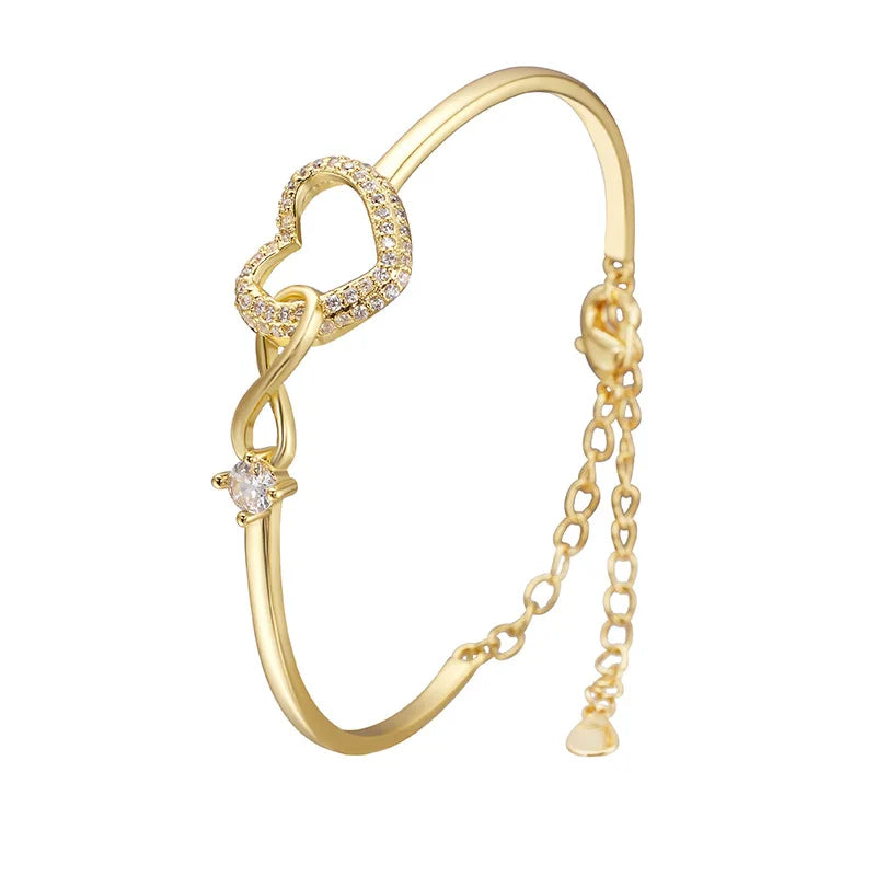 Gold bracelet with heart design on a white background