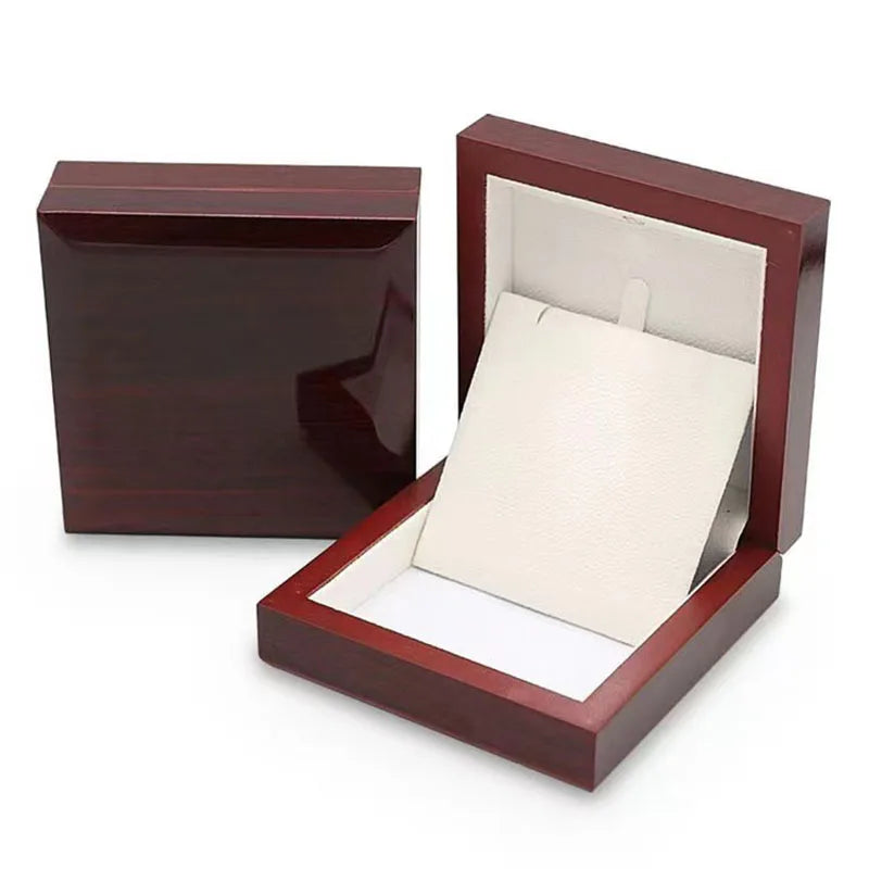 Wooden jewelry box with a watch inside on a white background