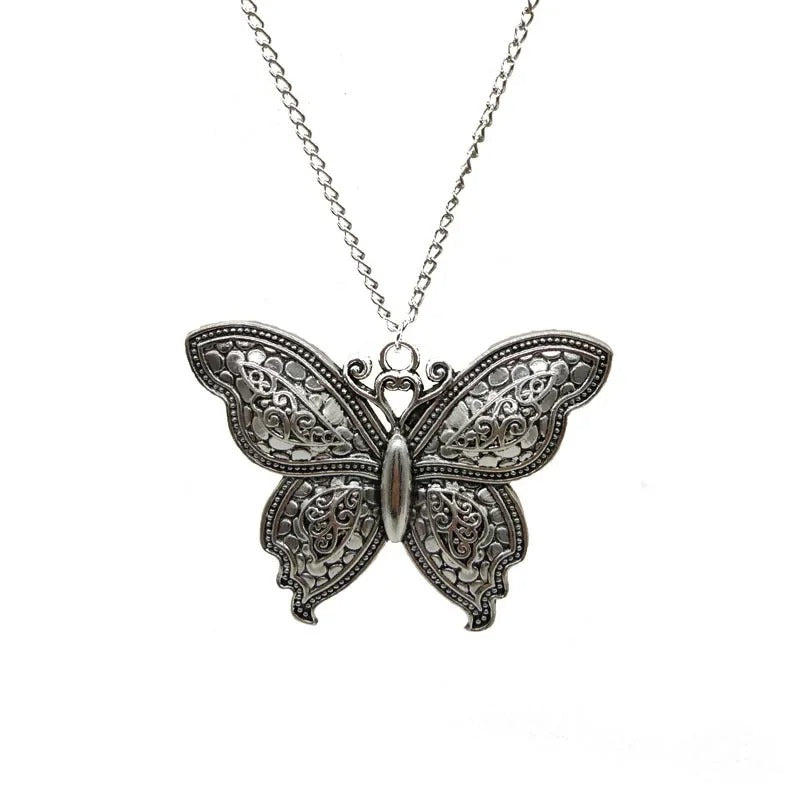 Butterfly-shaped pendant on a chain against a white background