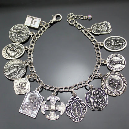 Silver charm bracelet with various charms on a dark background