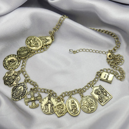 Gold charm bracelet on a soft fabric background