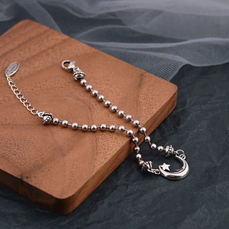 Silver chain with a clasp on a wooden block