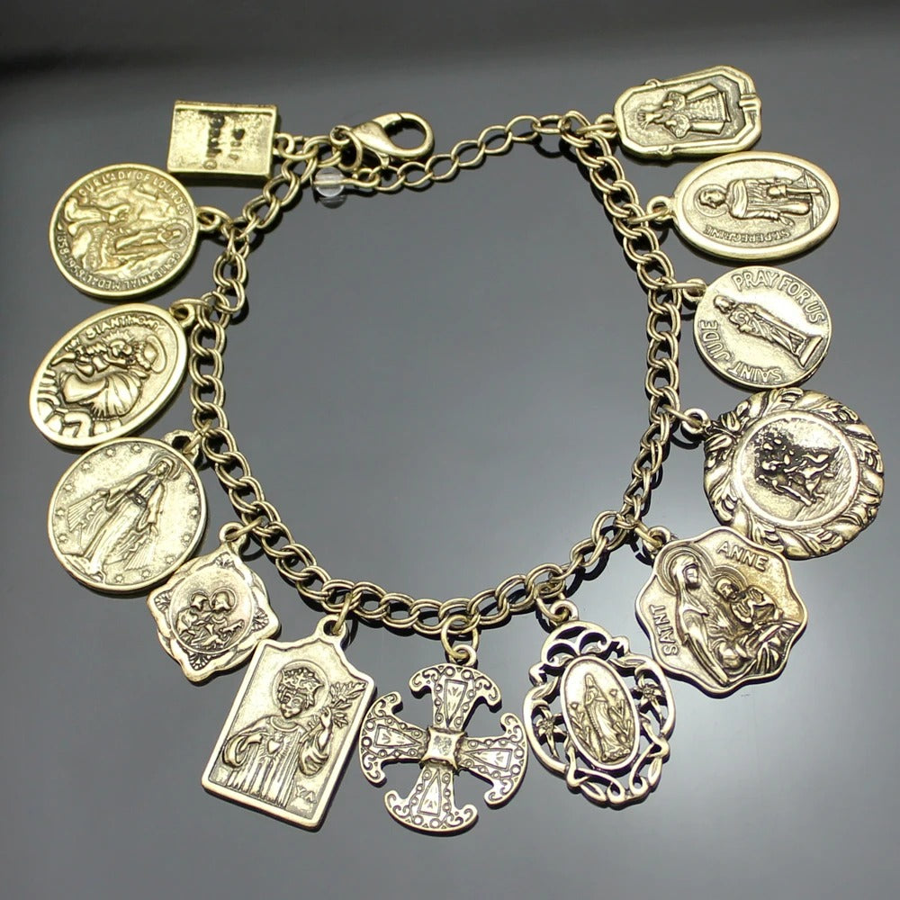Gold bracelet with various charms on a dark background