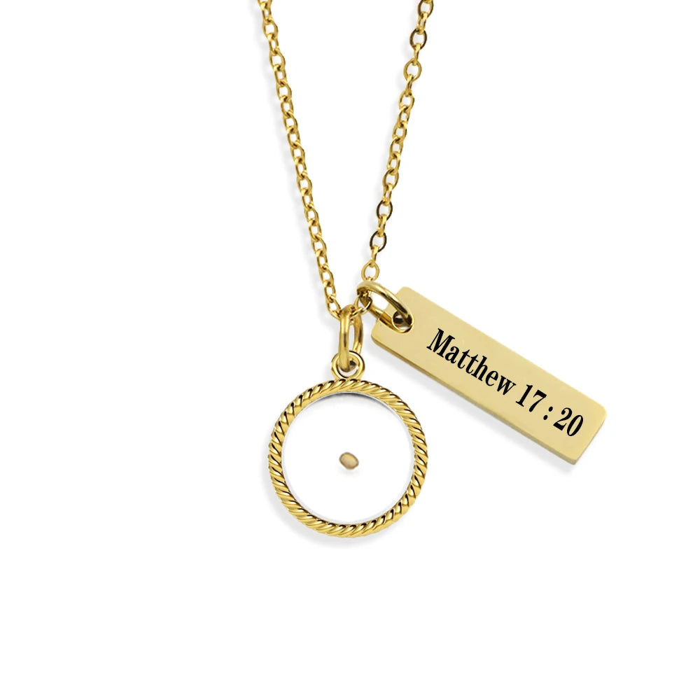 Gold necklace with circular pendant and engraved bar on a white background