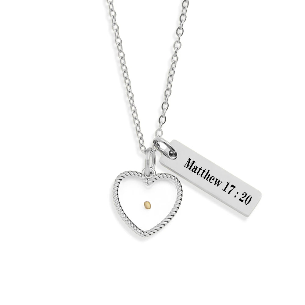 Silver necklace with heart pendant and engraved bar on a white background
