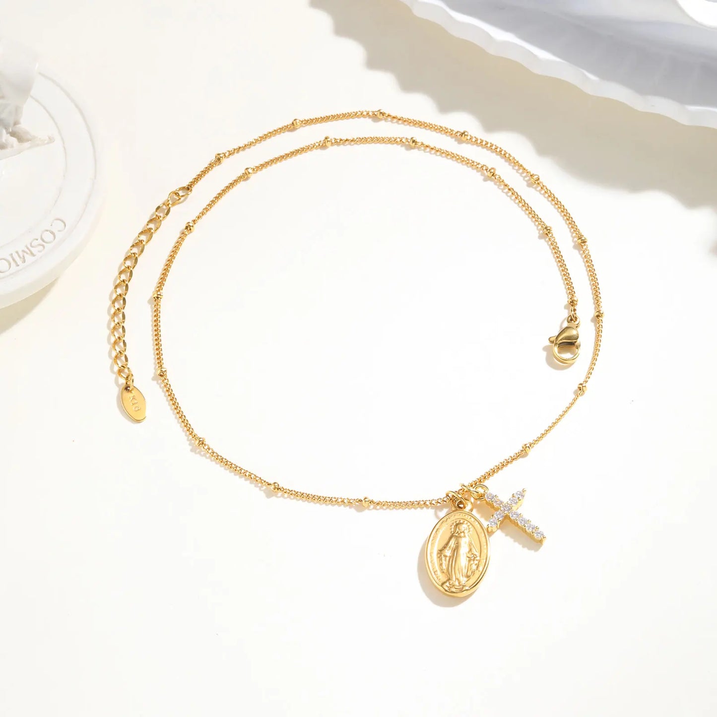 Gold necklace with pendant on a white background