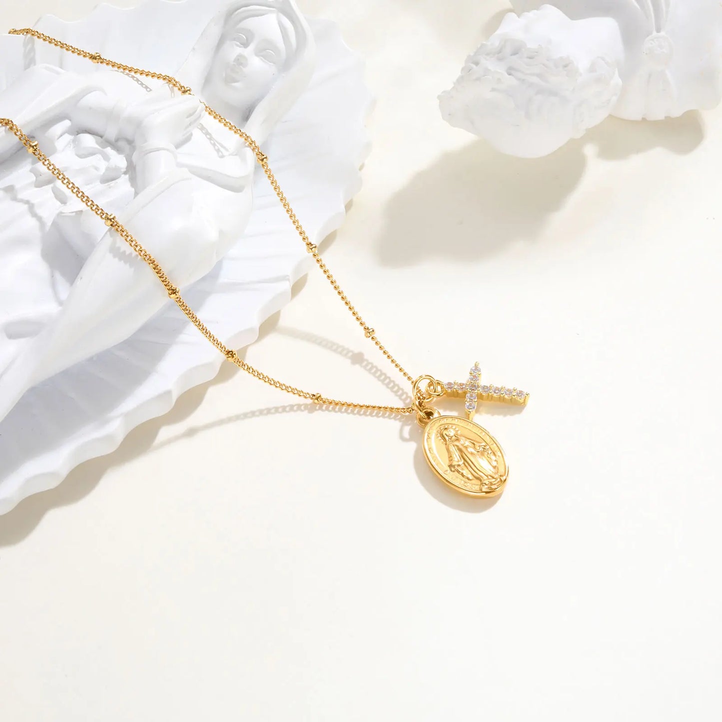 Gold necklace with a pendant on a white background