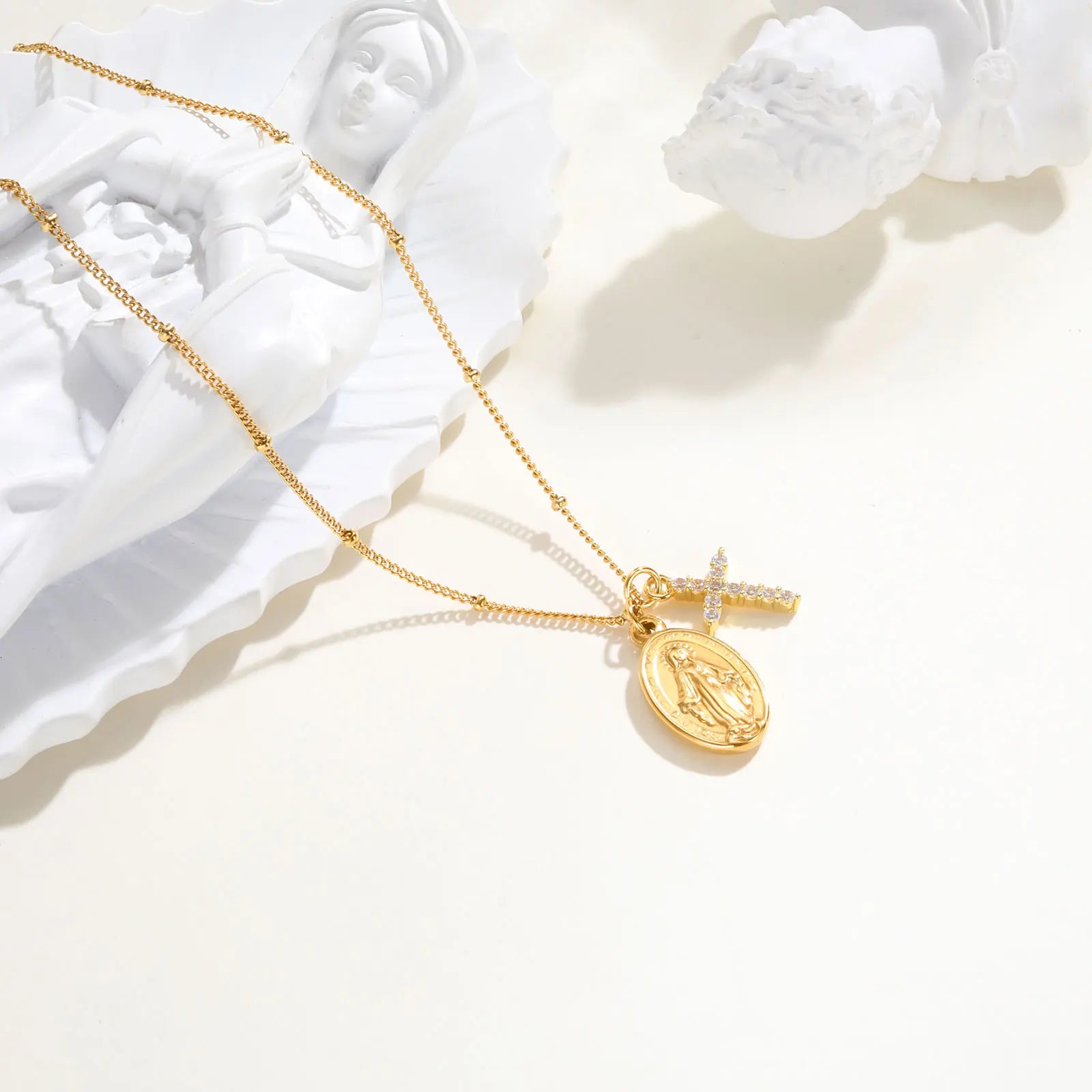 Gold necklace with a pendant on a white background
