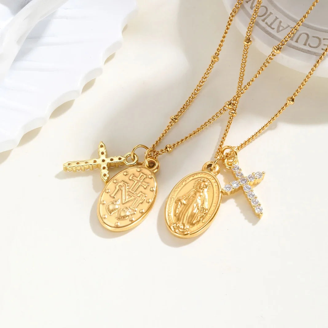 Two gold necklaces with various pendants on a white background