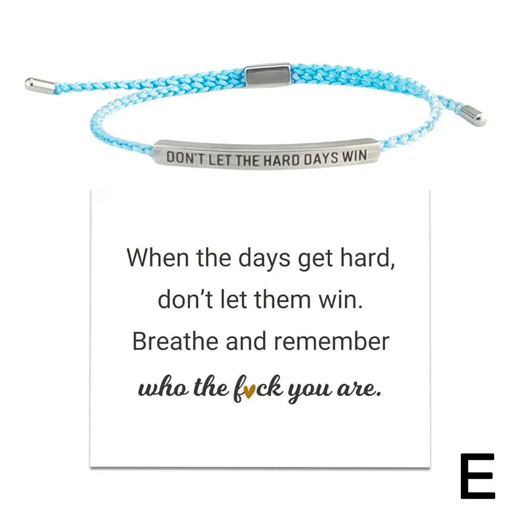 Blue braided bracelet with motivational message on a white background
