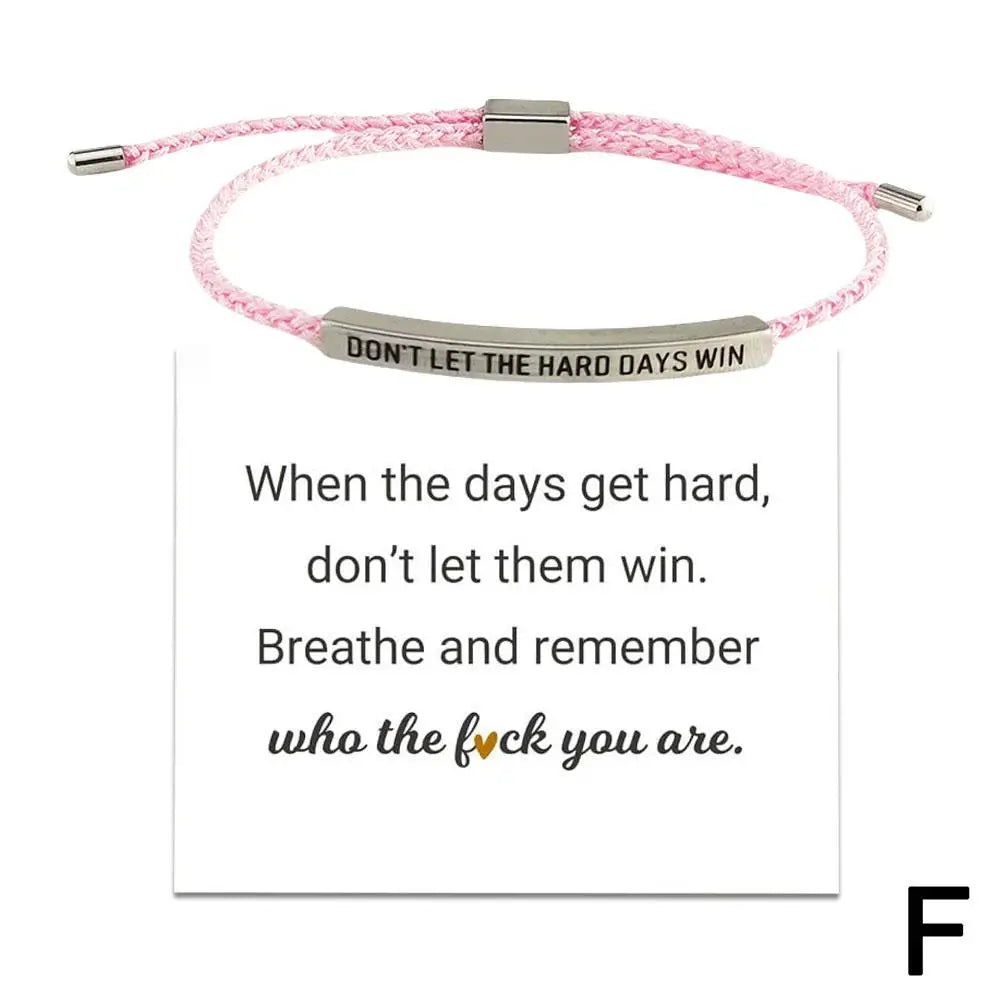 Pink braided bracelet with motivational message on a white background