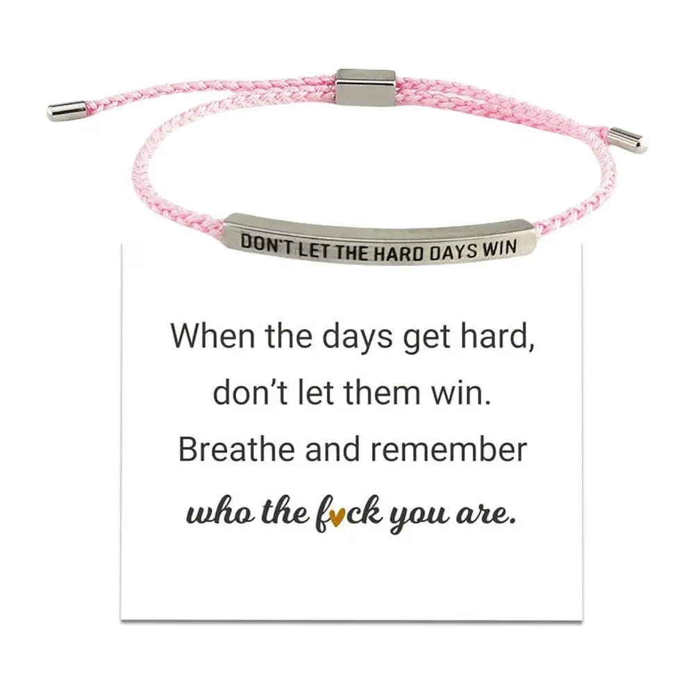 Pink braided bracelet with motivational message on a white background