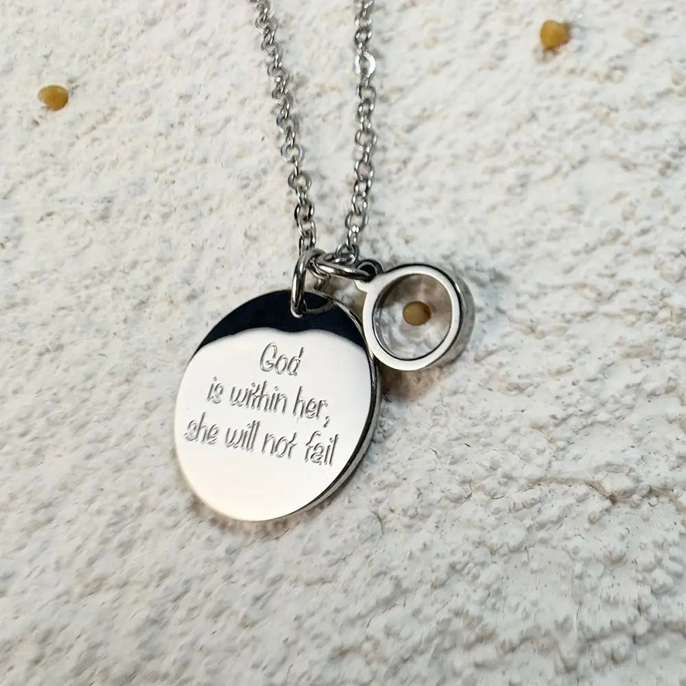 Silver necklace with a pendant on a textured surface