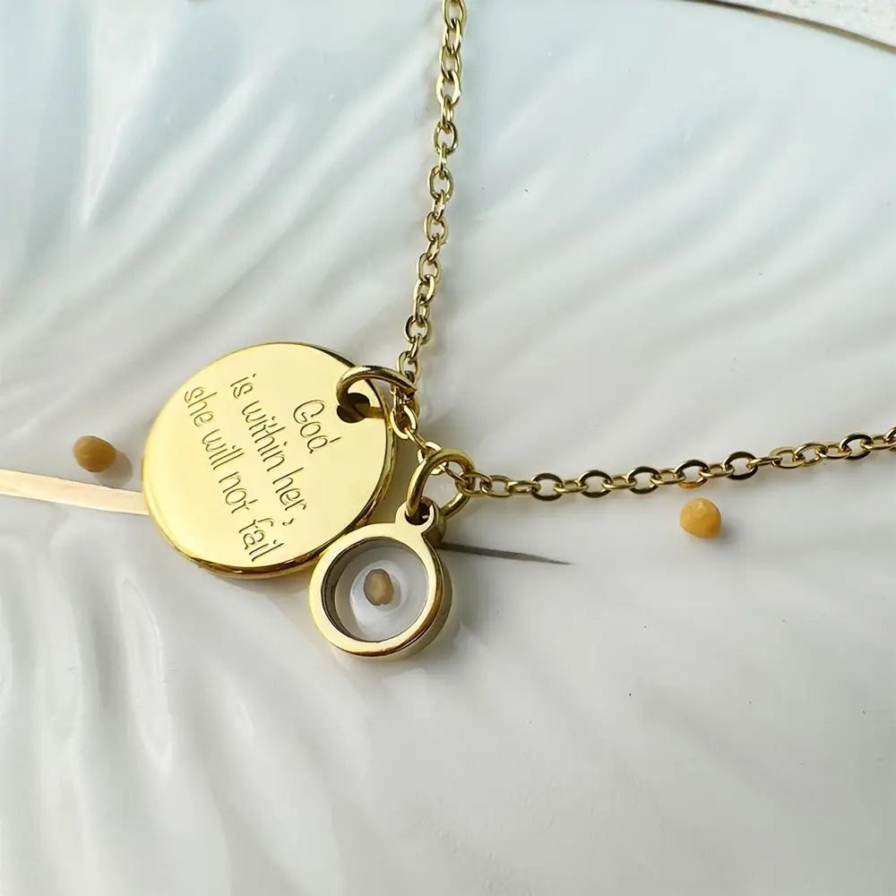 Gold necklace with two round pendants on a light background
