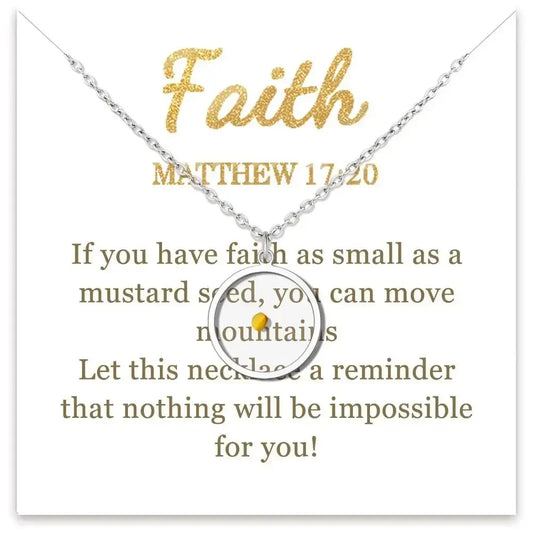 A silver necklace with a circular pendant featuring a small gold dot, displayed on a white card with gold text reading 'Faith' and 'MATTHEW 17:20' plus a message about mustard seed faith.